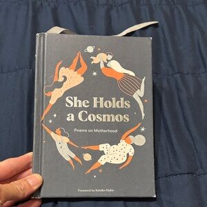 She Holds a Cosmos Poetry Book